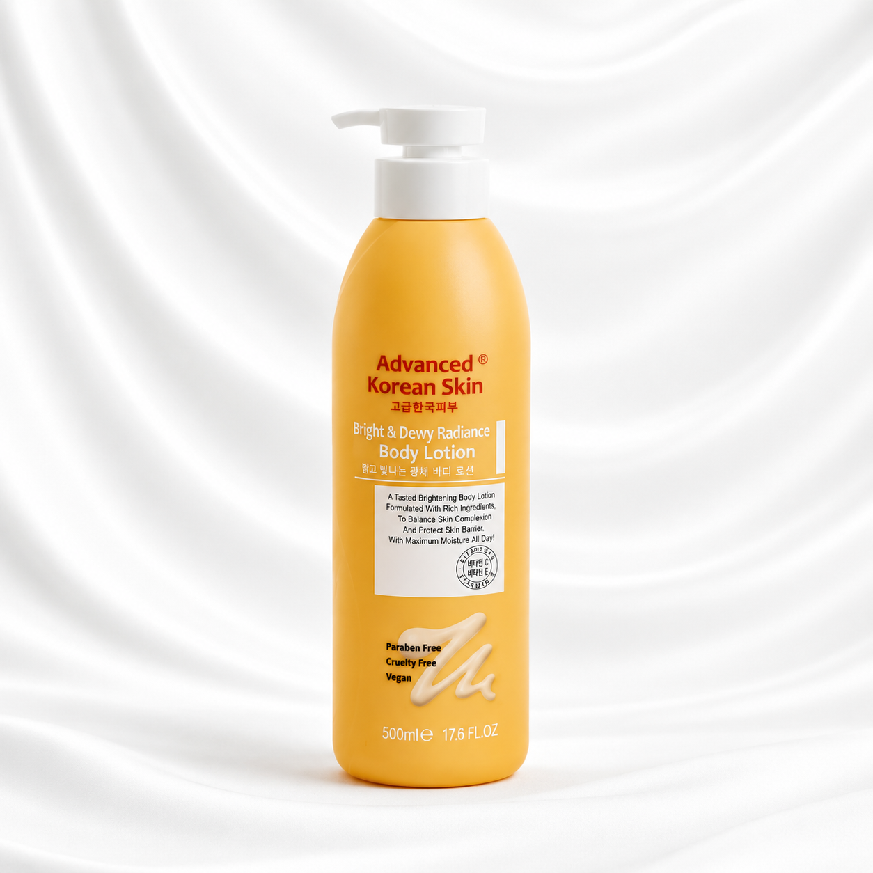 A 500ml bottle of Advanced Korean Skin Bright & Daily Radiance Body Lotion, featuring a bright yellow-orange body with a white pump dispenser, set against a white satin fabric background.