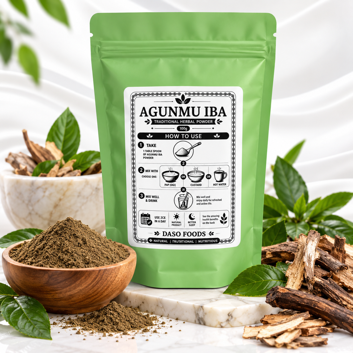 A green stand-up pouch labeled AGUNMU IBA by Daso Foods, styled on a marble surface with a wooden bowl of powder, loose bark pieces, and green leaves around it.