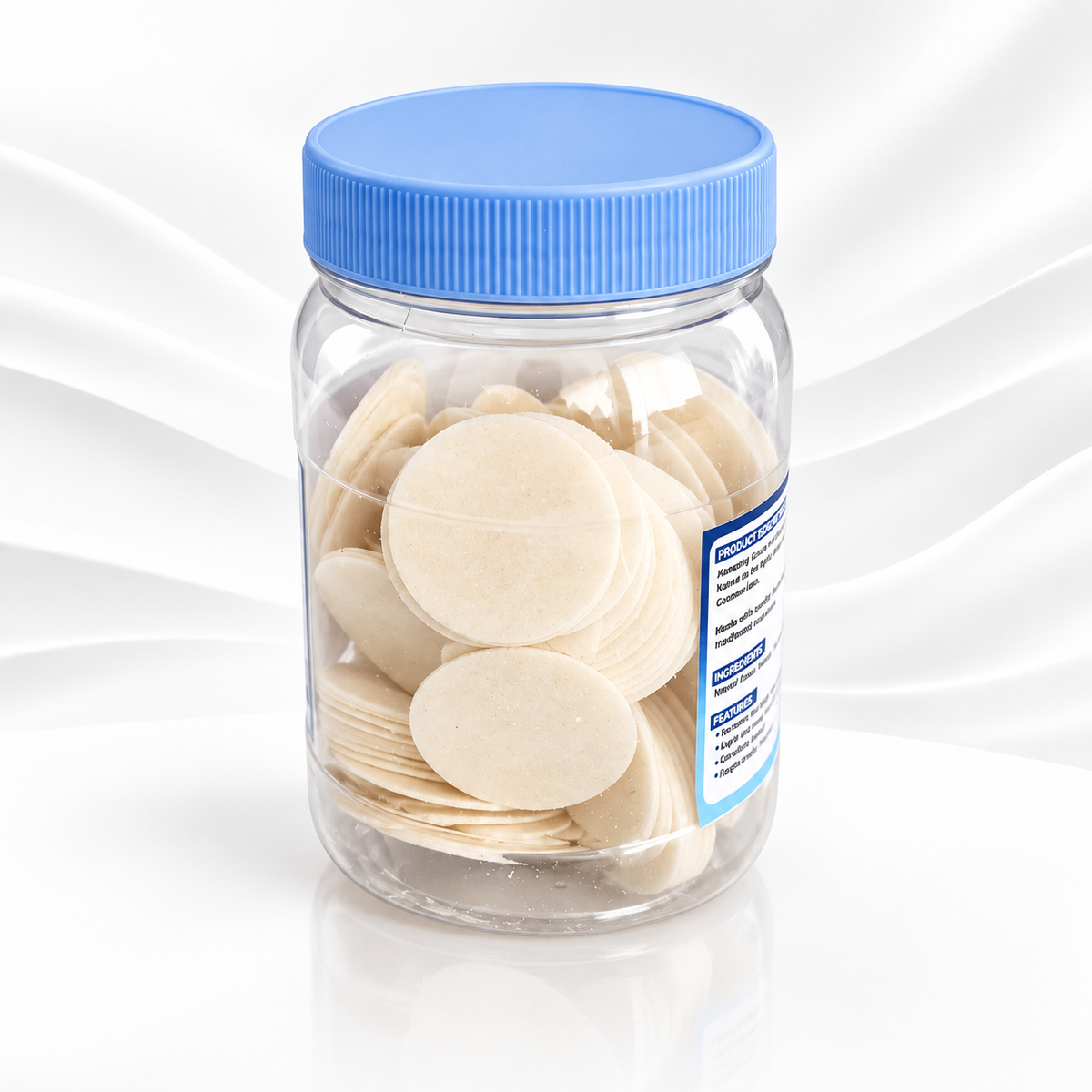 A clear plastic jar filled with round off-white discs, sealed with a bright blue screw-on lid, shown on a clean white background with a subtle wave pattern.