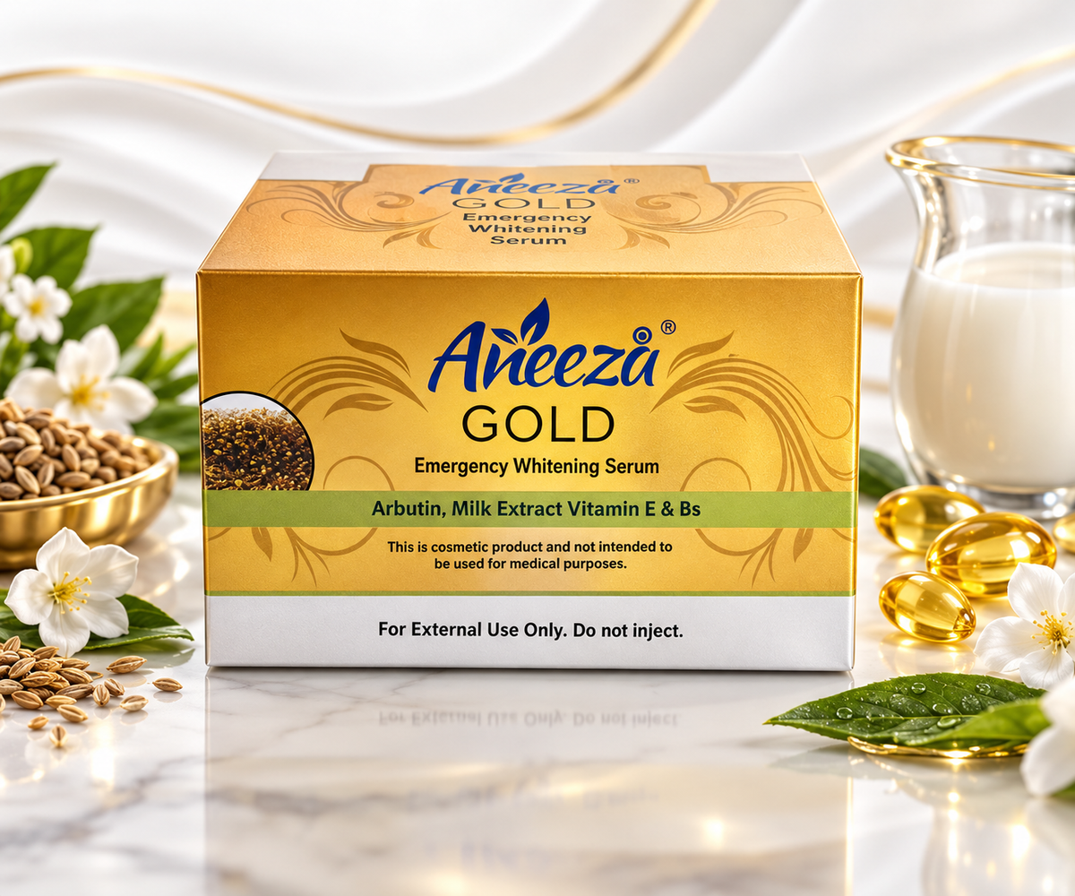 A box of Areeza Gold Emergency Whitening Serum centered on a marble surface, surrounded by decorative props including a glass of milk, golden capsules, seeds, green leaves, and white flowers. The box is gold and white with blue and green branding.