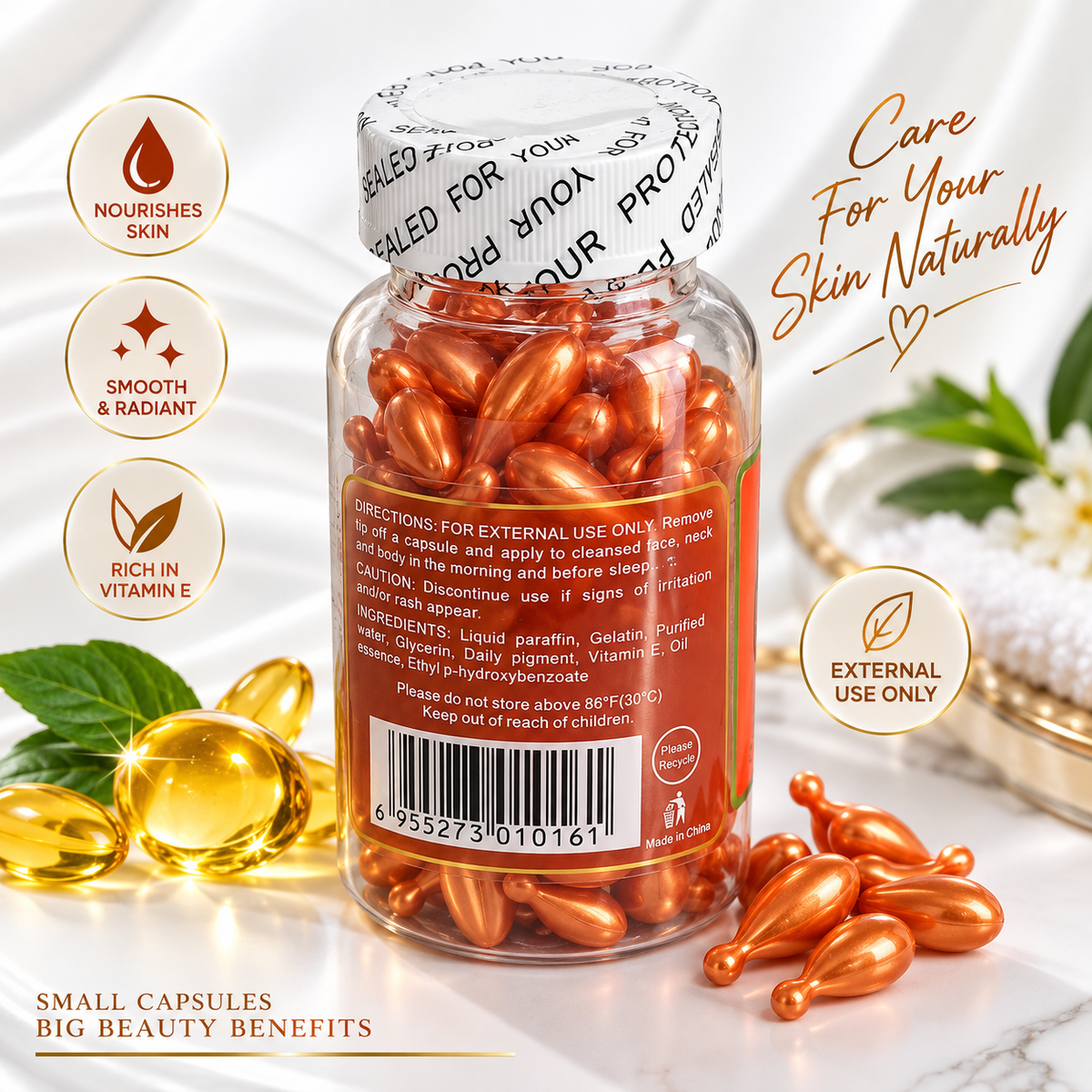 A clear bottle of orange-colored cosmetic capsules with a white printed cap, shown on a light marble surface with decorative gold capsules, a white flower, and marketing text. The bottle label includes a barcode and usage warning, and the left side has circular callouts reading 'Nourishes Skin,' 'Smooth & Radiant,' and 'Rich in Vitamin E.