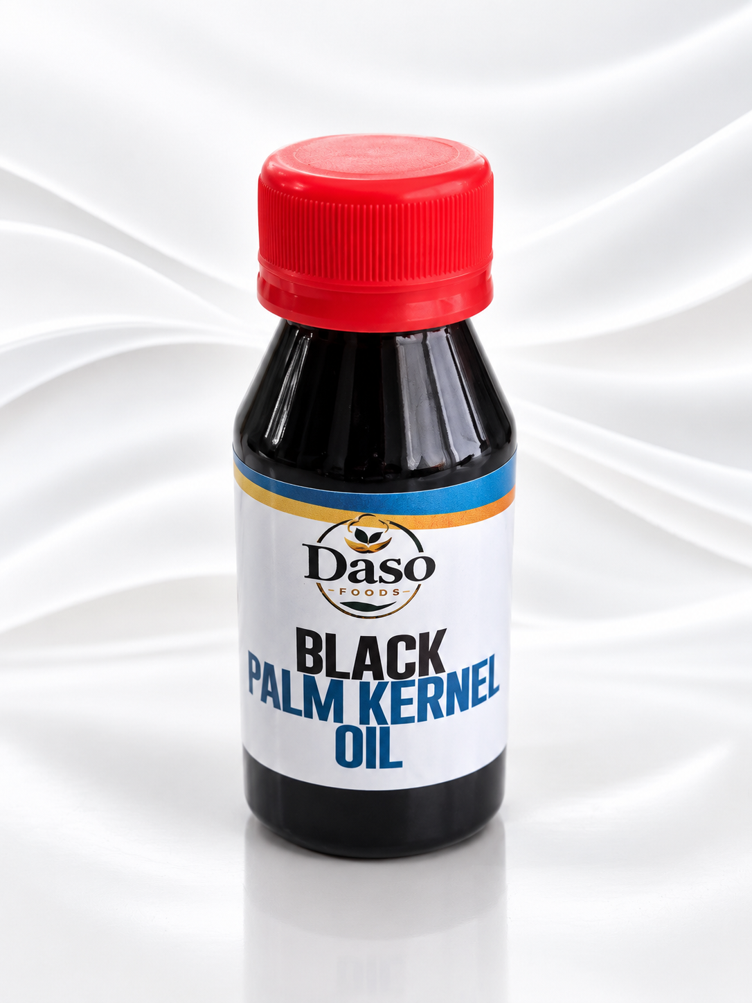 A bottle of Daso Foods Black Palm Kernel Oil with a red cap and a white label, set against a white draped fabric background.