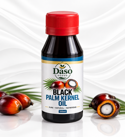 A 100ml bottle of Daso Foods Black Palm Kernel Oil, featuring a red cap and a white label with palm kernel illustrations, set against a white background with decorative palm kernels.