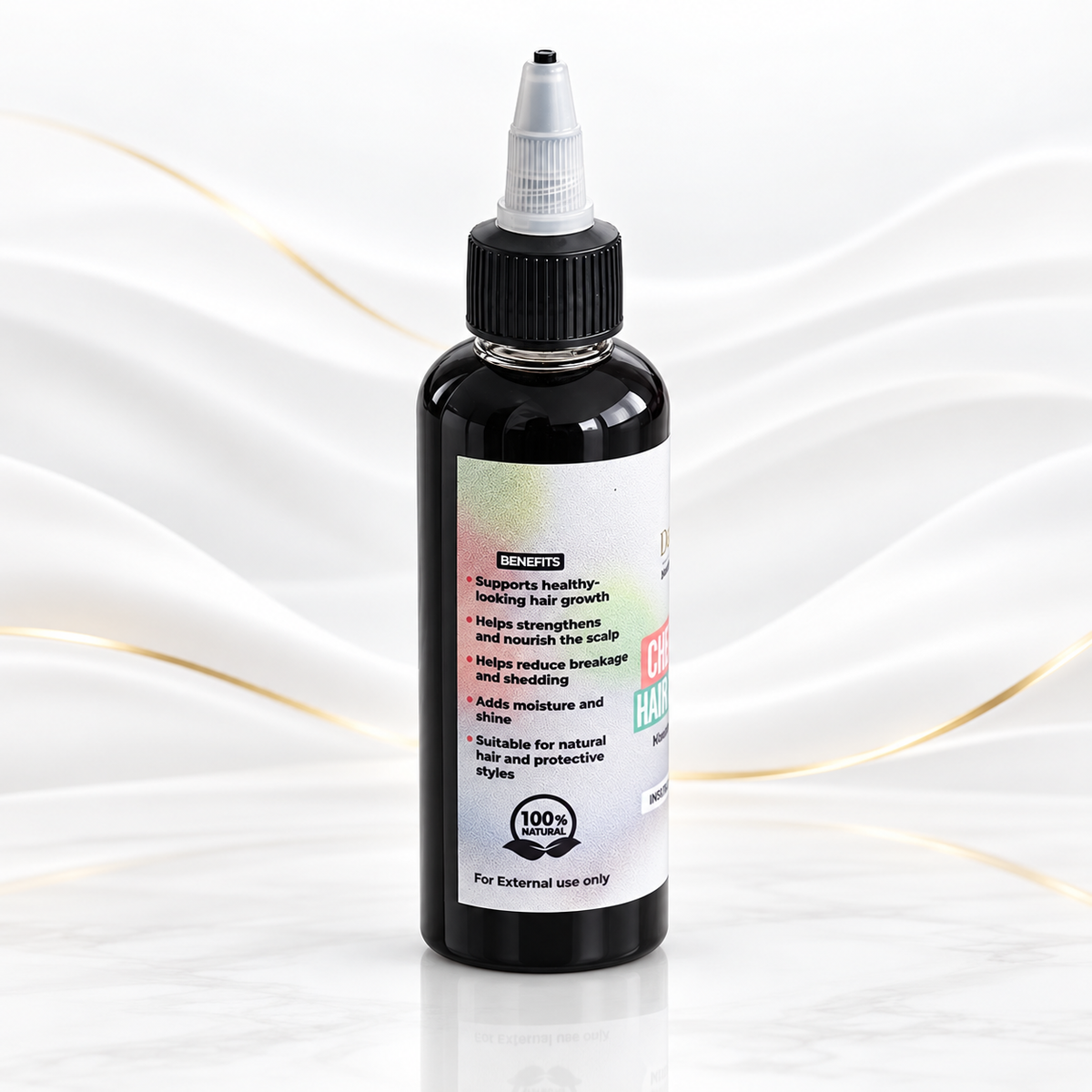 A bottle of KENOPS Scalp Hair Growth Serum with a black body, black cap, and white label, set against a white marble background with soft gold wavy lines.