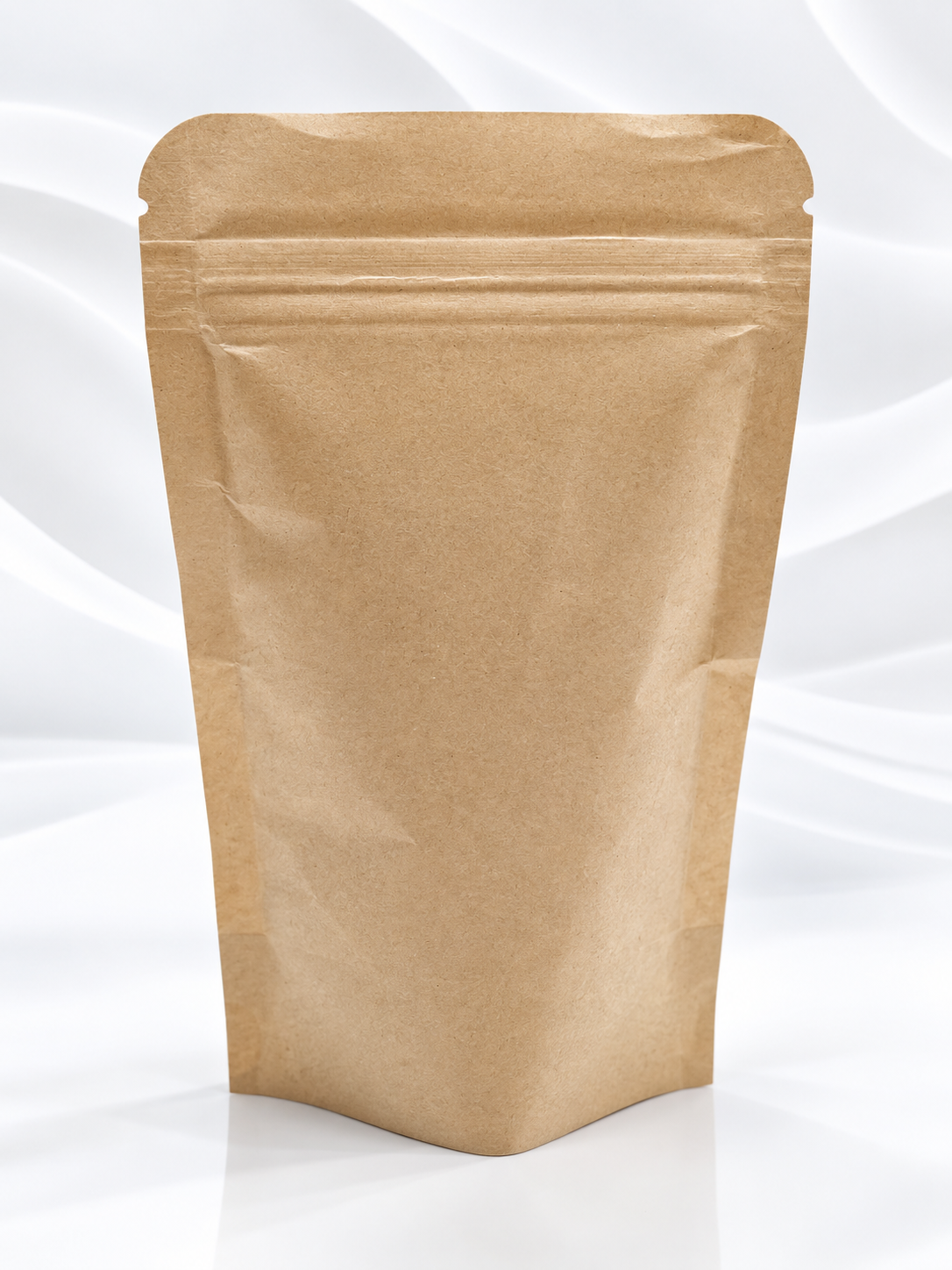 A blank brown kraft paper stand-up pouch with a resealable zipper, shown on a white background with soft gray wavy lines.
