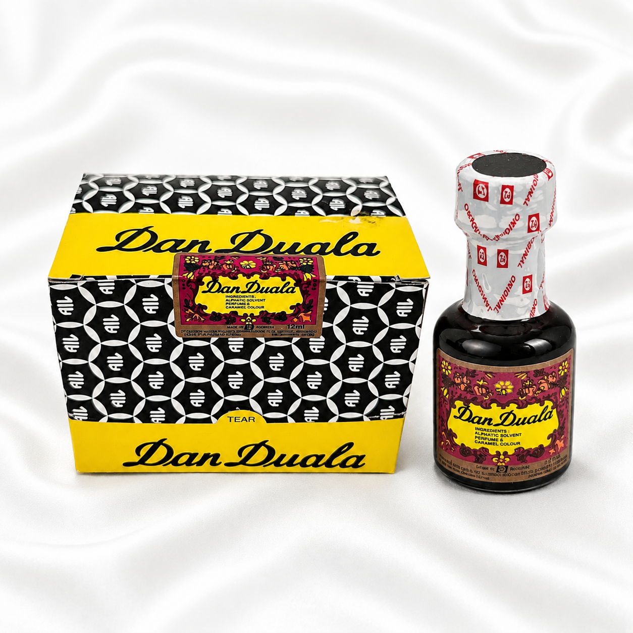 Dan Duala tea product shown with its patterned outer box and a small dark glass bottle on a white satin-like background.