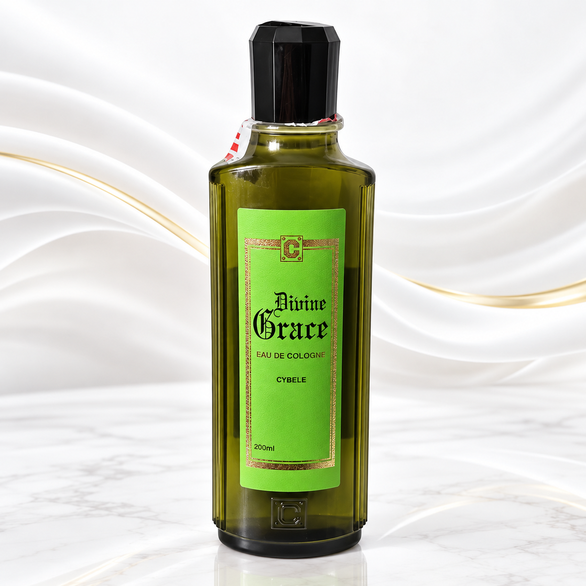 A 200ml bottle of Divine Grace Eau de Cologne (Cybele) featuring a translucent olive-green glass body, a bright green label with gold borders, and a black cap, set against a white marble background with elegant gold wavy lines.