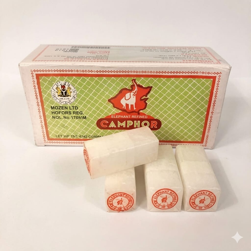 Camphor sticks with their branded packaging box, displayed on a clean white background. The box is cream and green with red accents, and four white camphor sticks are arranged in front, with three showing the red and white circular logo.
