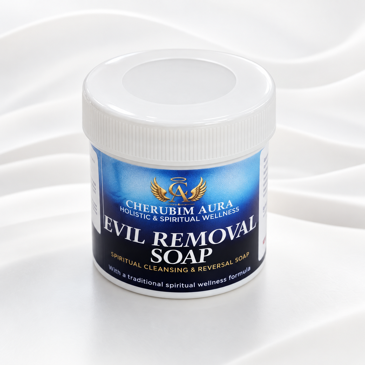 A white plastic jar of Cherubim Aura Evil Removal Soap with a blue and white label, set against a white background with soft, wavy fabric folds.