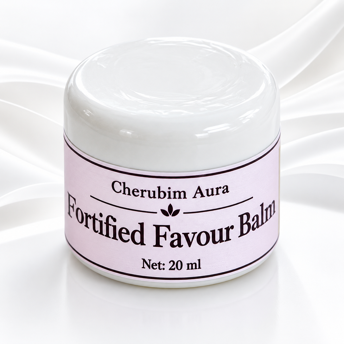 A white cosmetic jar of Cherubim Aura Fortified Favour Balm with a light pink label, set against a white background with elegant draped fabric.