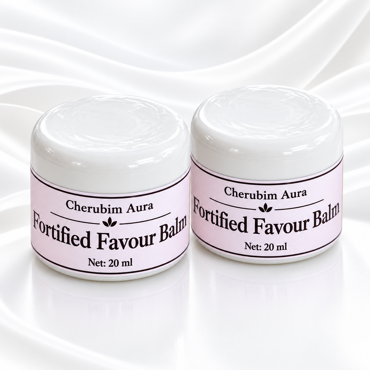 A 20 ml jar of Cherubim Aura Fortified Favour Balm, featuring a white lid with a dollop of white balm on top and a light purple label, set against a white satin background.