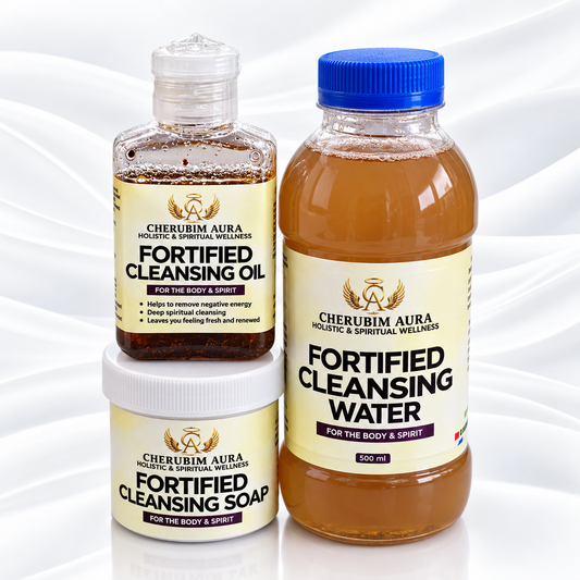 Three Cherubim Aura cleansing products arranged together on a white satin-like background: a bottle of fortified cleansing oil, a bottle of fortified cleansing water with a blue cap, and a jar of fortified cleansing soap.