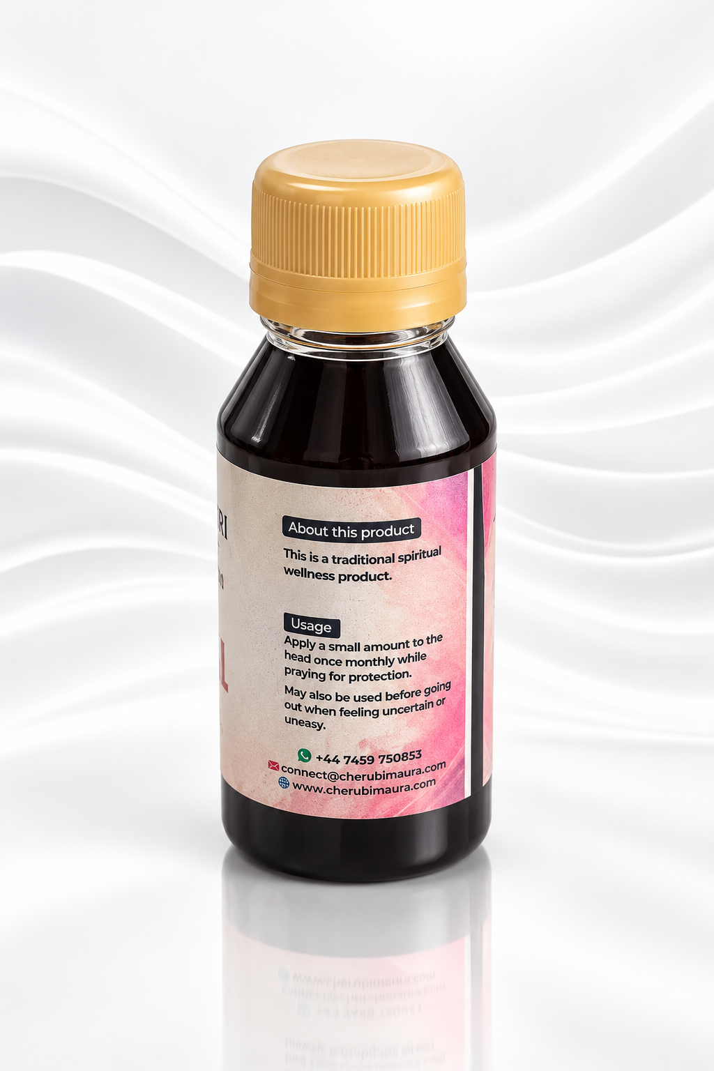 A small dark bottle with a gold cap and a pink label, photographed on a white background with soft wavy lines and a reflection below.