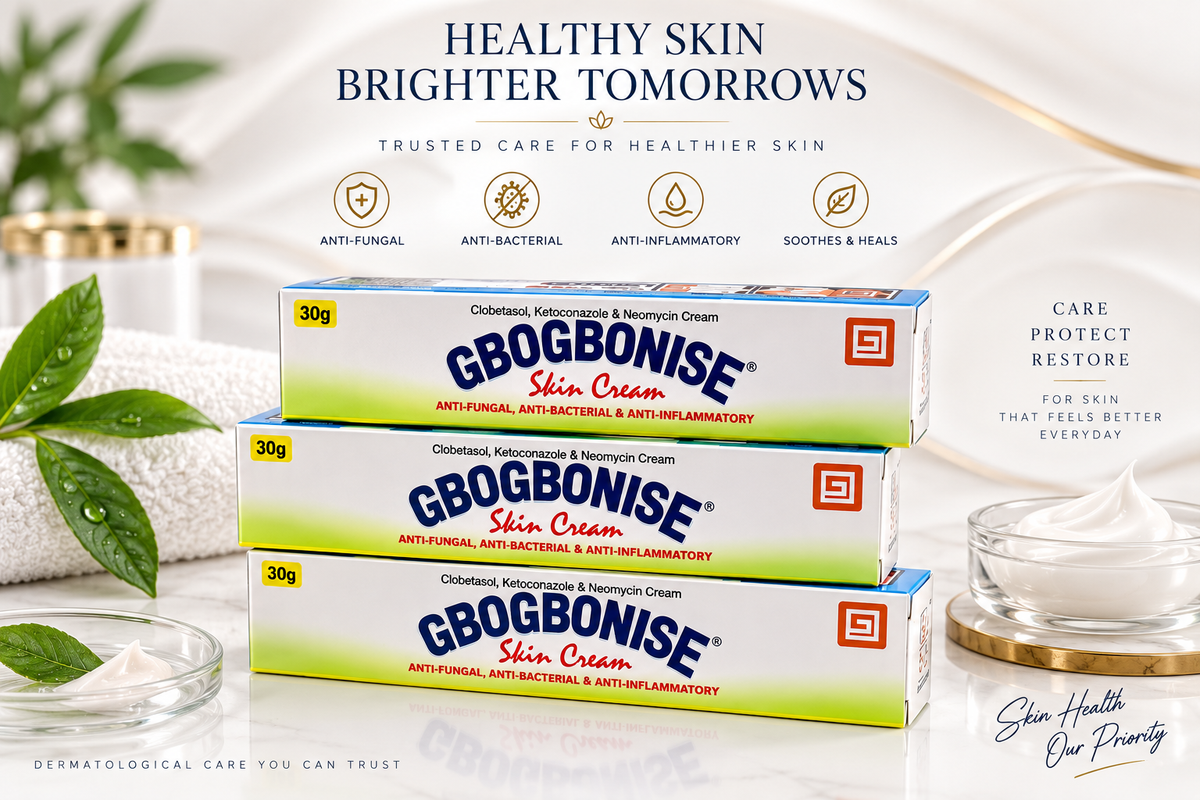 Three boxes of Gbogbonise Skin Cream stacked on a reflective white surface, with a glass bowl of cream, a gold candle, and green leaves in the background. The image features promotional text and icons for skin care benefits.
