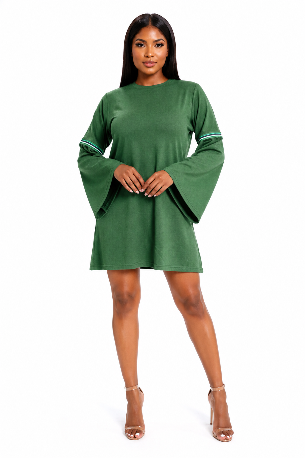 A woman modeling a green mini dress with wide bell sleeves and thin white stripes on the cuffs, paired with nude high-heeled sandals against a plain white background.