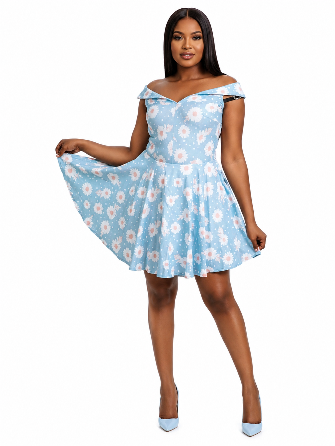 A woman modeling a light blue off-the-shoulder mini dress with a white and pink daisy floral pattern, posed against a solid white background.