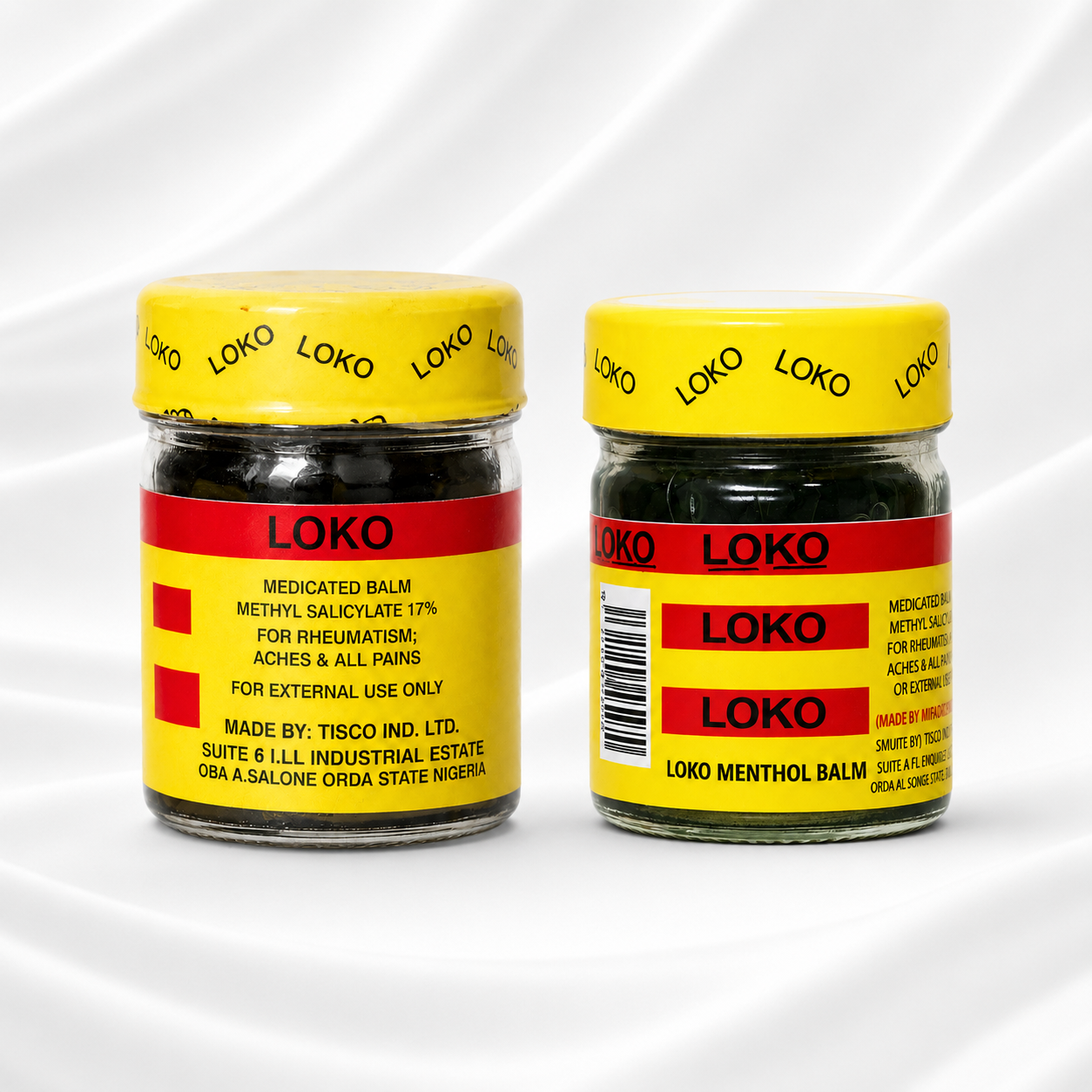 Two jars of Loko Medicated Balm shown on a white draped fabric background. The jars have yellow lids and yellow labels with red bands and black text, showing both the front and side views of the packaging.