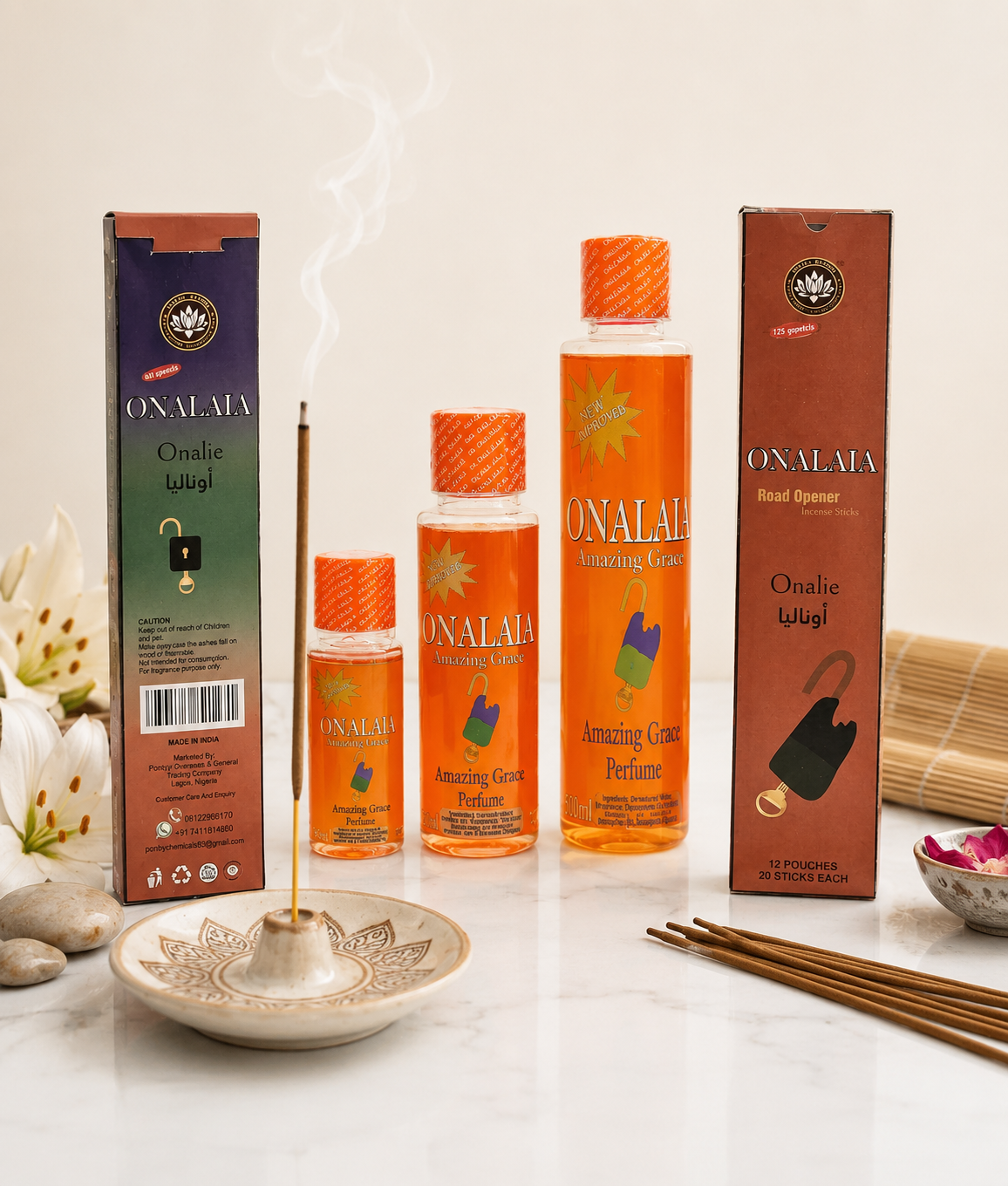 Onalaa perfume bottles and incense sticks on a white surface with packaging.