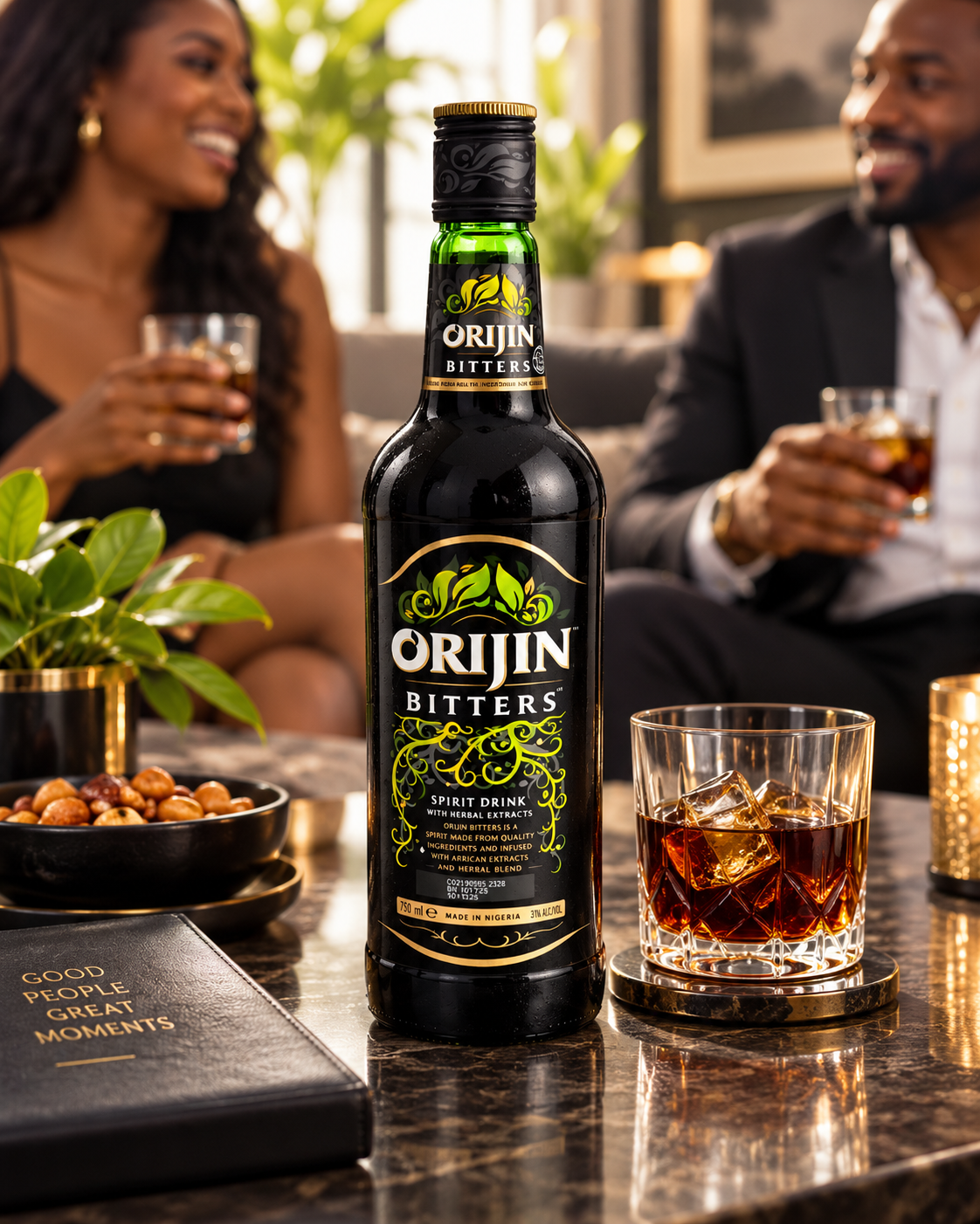 A bottle of Orijin Bitters spirit drink stands on a polished bar counter, with a filled rocks glass beside it. Two people are seated in the softly blurred background, each holding a glass.