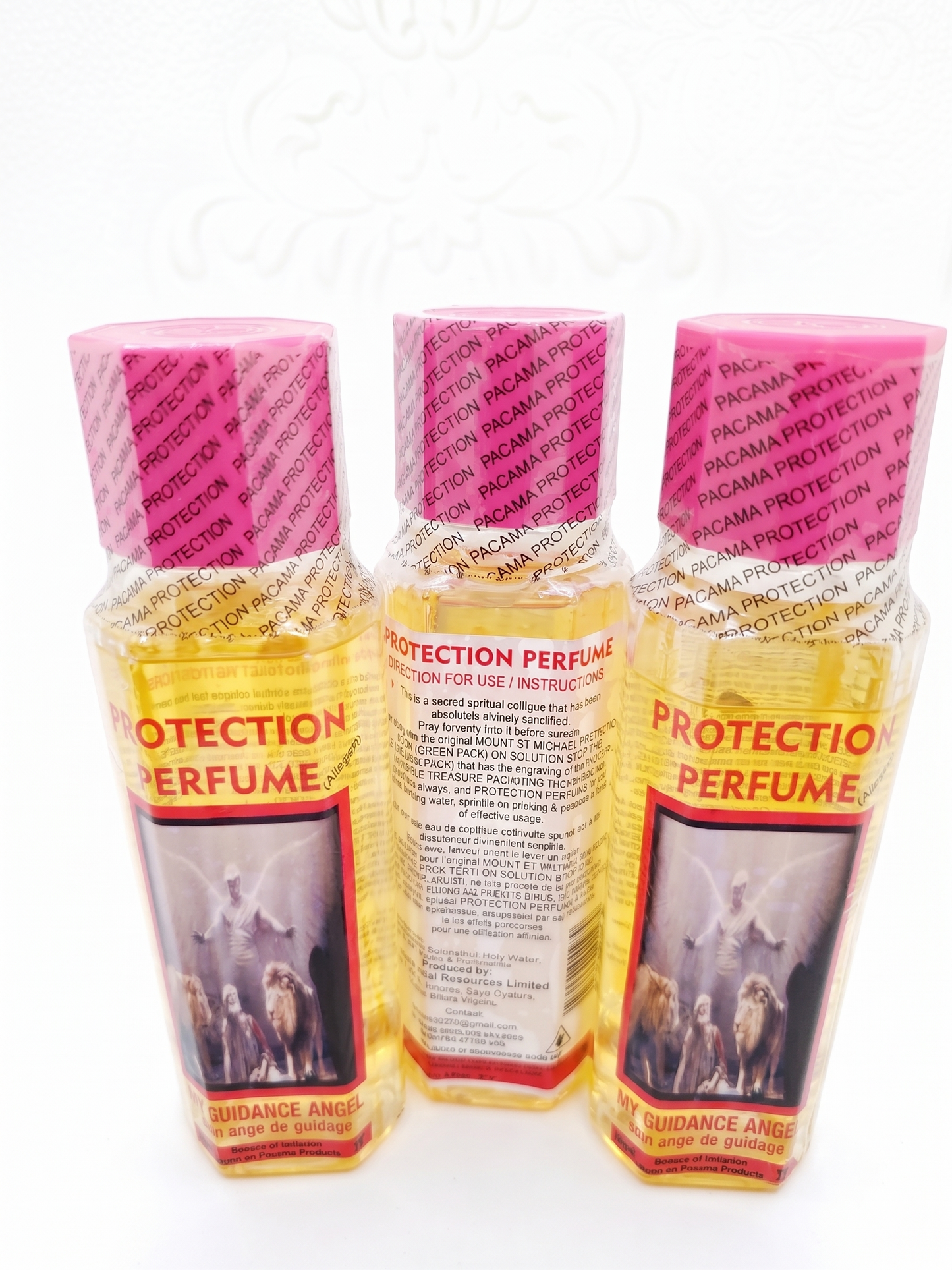 Three bottles of 'Protection Perfume' with pink and yellow packaging on a white background.