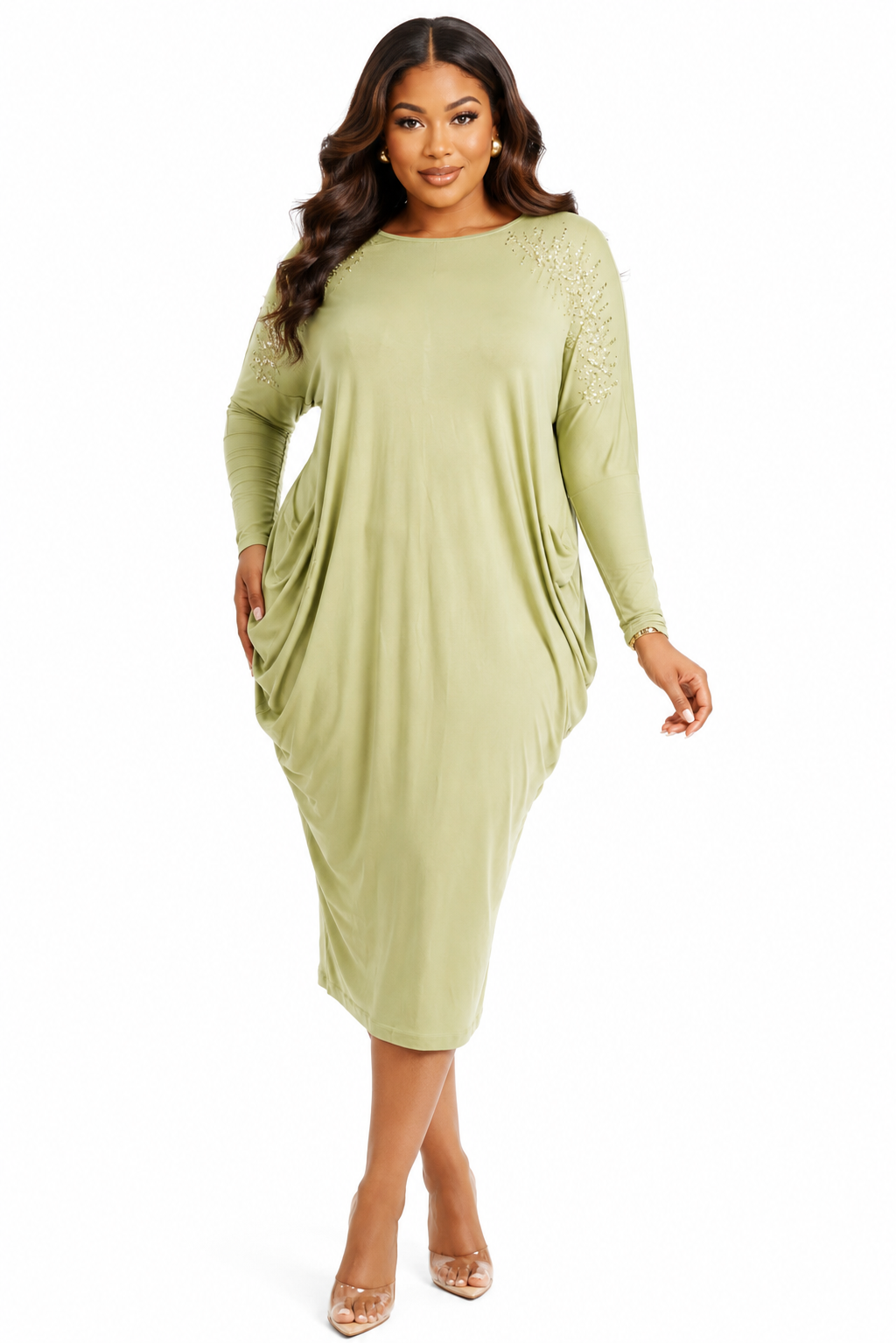 A woman modeling a sage green long-sleeve midi dress with lace detailing on the upper sleeves, set against a plain white background.