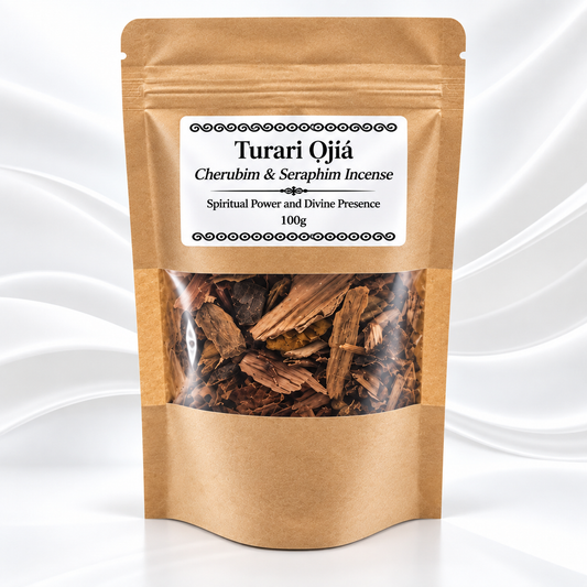 A 100g kraft paper pouch of Turari Ojiáa incense, featuring a clear window that displays the brown wood chips inside. The label reads 'Turari Ojiáa Cherubim & Seraphim Incense' and is set against a white background with elegant wavy drapery.