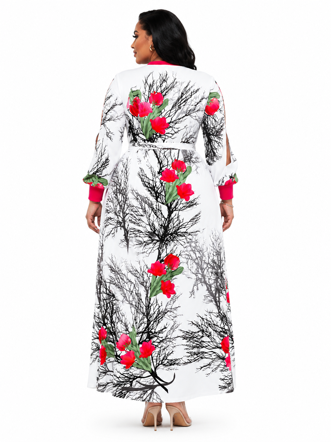 A woman shown from the back wearing a long white robe with a black branch pattern and bright red floral accents, photographed against a plain white studio background.