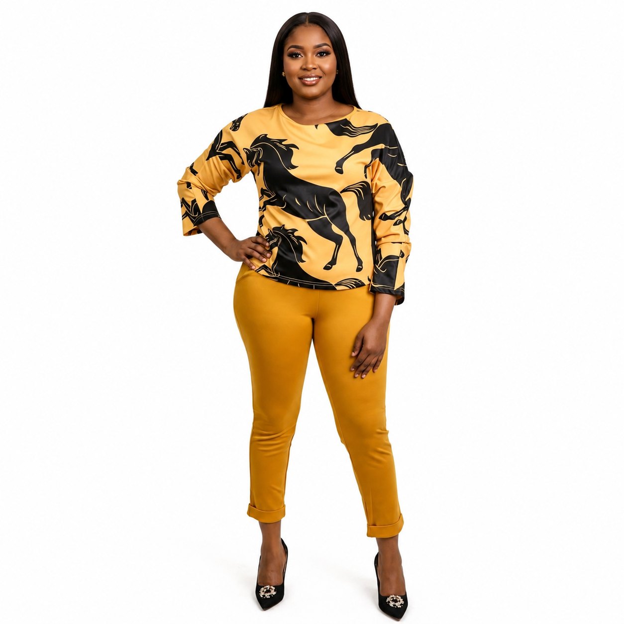 A woman modeling a yellow and black horse-patterned long-sleeve top paired with matching yellow cropped pants and black pointed heels, set against a plain white background.